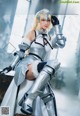 A woman in armor sitting on top of a table.