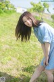 A woman in a blue dress is posing for a picture.