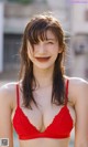 A woman in a red bikini posing for a picture.