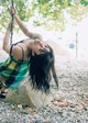 A woman is swinging on a rope in a park.